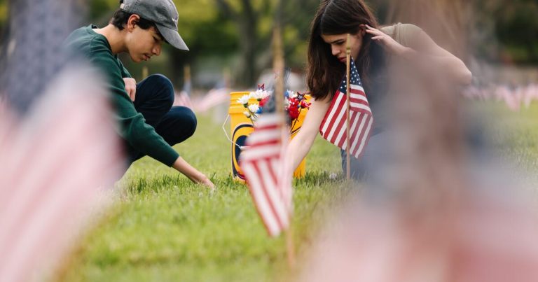 A family tends to a grave at Los Angeles National Cemetery